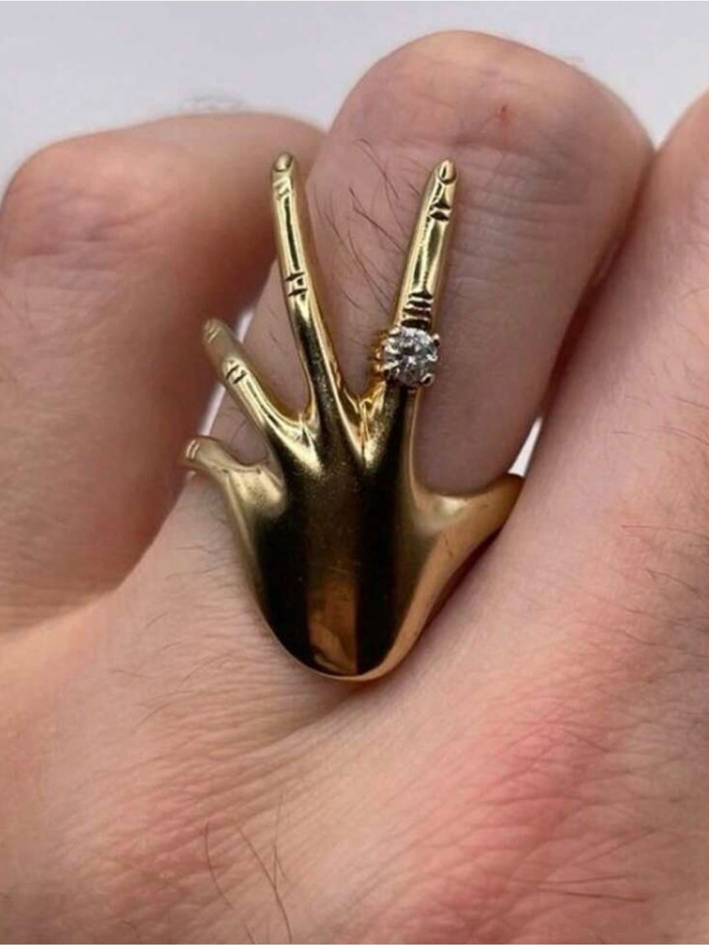 Gold Hand-Shaped Ring with Clear Stone